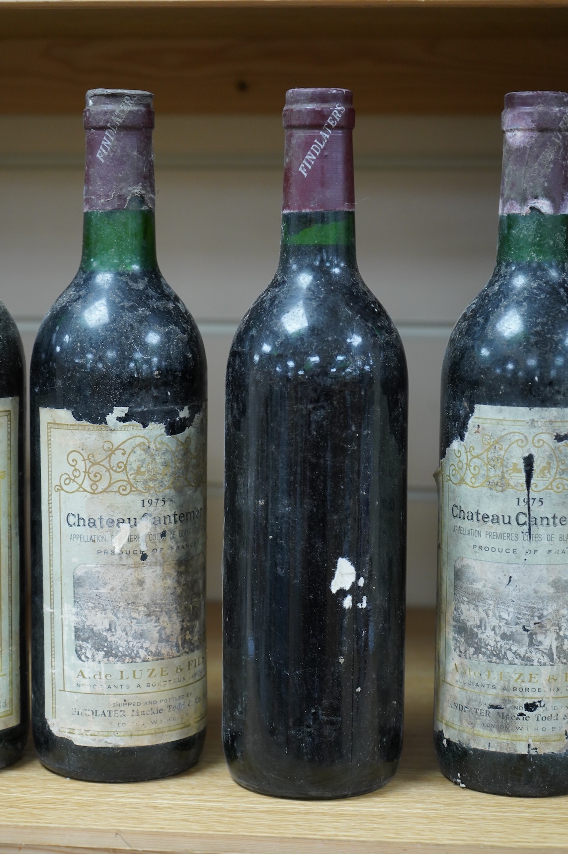 Five bottles of Chateau Cantemerle, 1975, labels degraded
